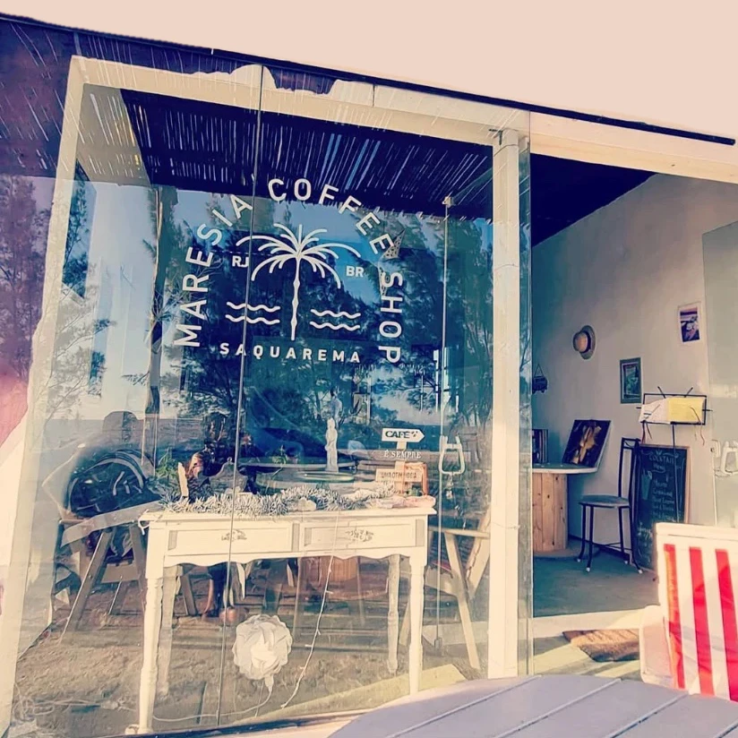 Fachada da Maresia Coffee Shop, em Saquarema: o logo em adesivo no vidro da porta.